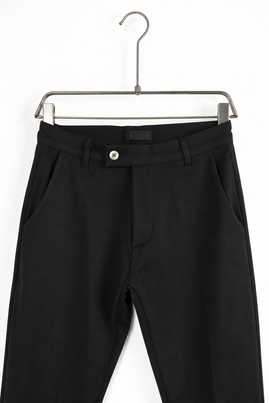Részlet: Fekete férfi slim fit nadrág. Látható elemek: zseb, gomb.